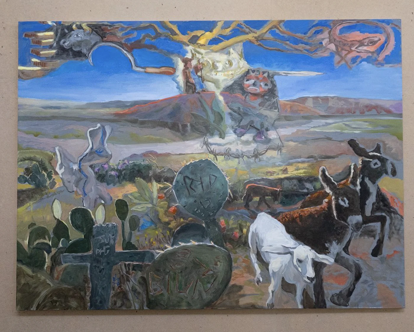 The Treasures of the Field: painting of donkeys and a white calf among carved gravestones, cacti with inscriptions, and a scythe-bearing figure in the clouds over a desert valley