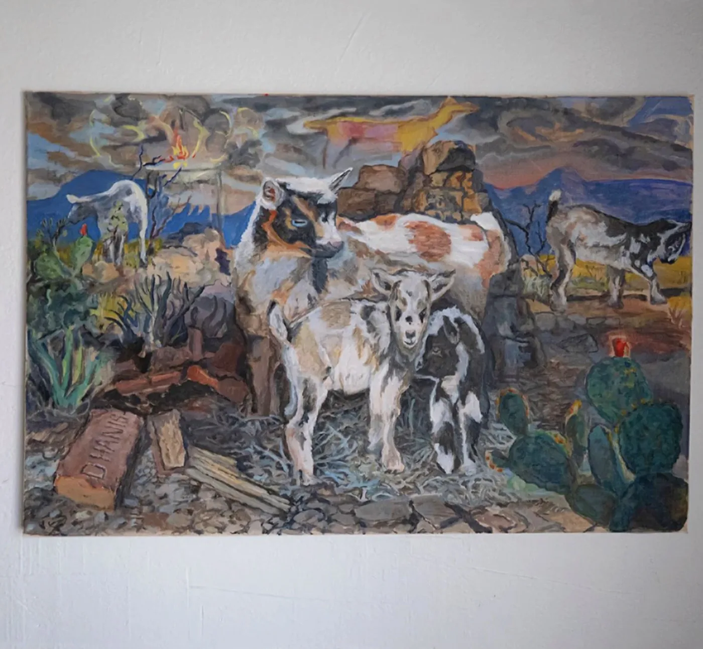 Goats and brick: oil painting of a goat family among prickly pear, rocks, and a D'Hanis brick, under a stormy sky with a burning tree and a yellow goat-shaped cloud