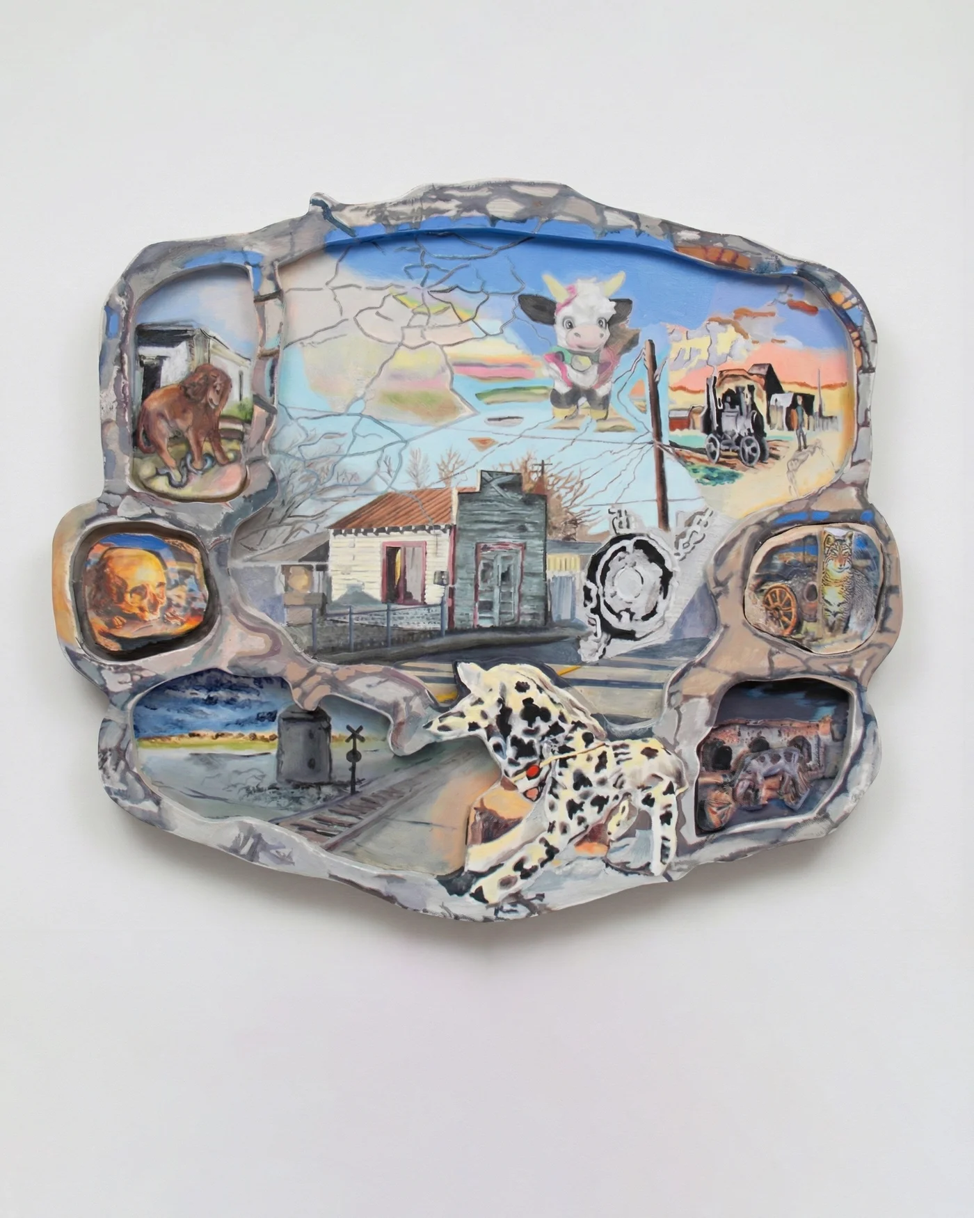 Irregular carved relief: a spotted toy horse leaps past a white house at a railroad crossing; surrounding pockets hold a spaniel, a skull beside a fire, a toy cow, a steam engine, a wildcat, and mission ruins under a cracked sky